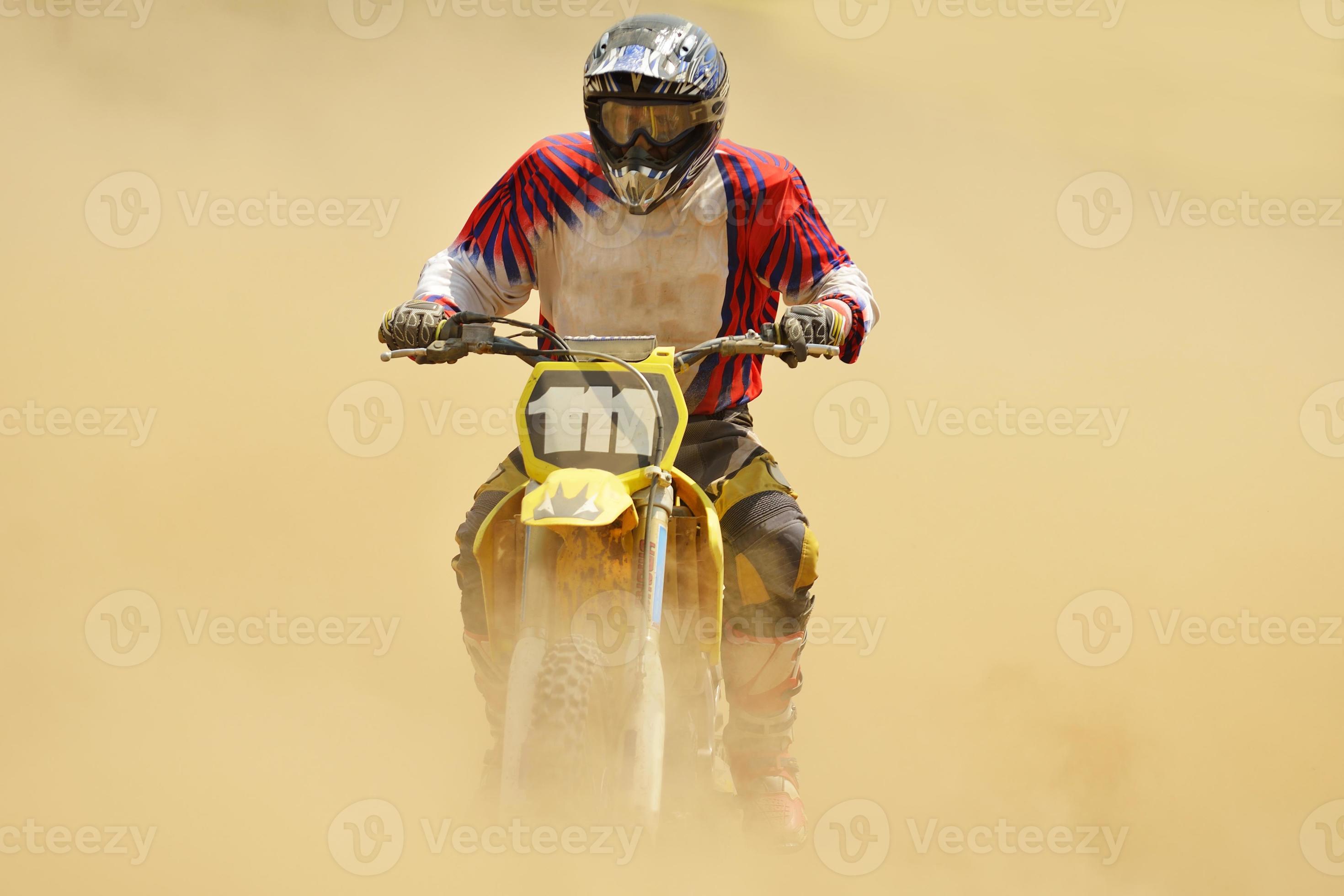 Motocross rider launching over a dirt jump during a championship race
